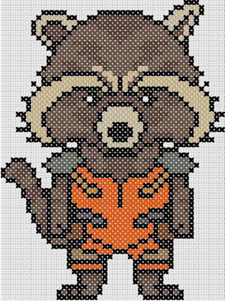 a cross stitch pattern with a raccoon wearing an orange outfit and holding a leaf