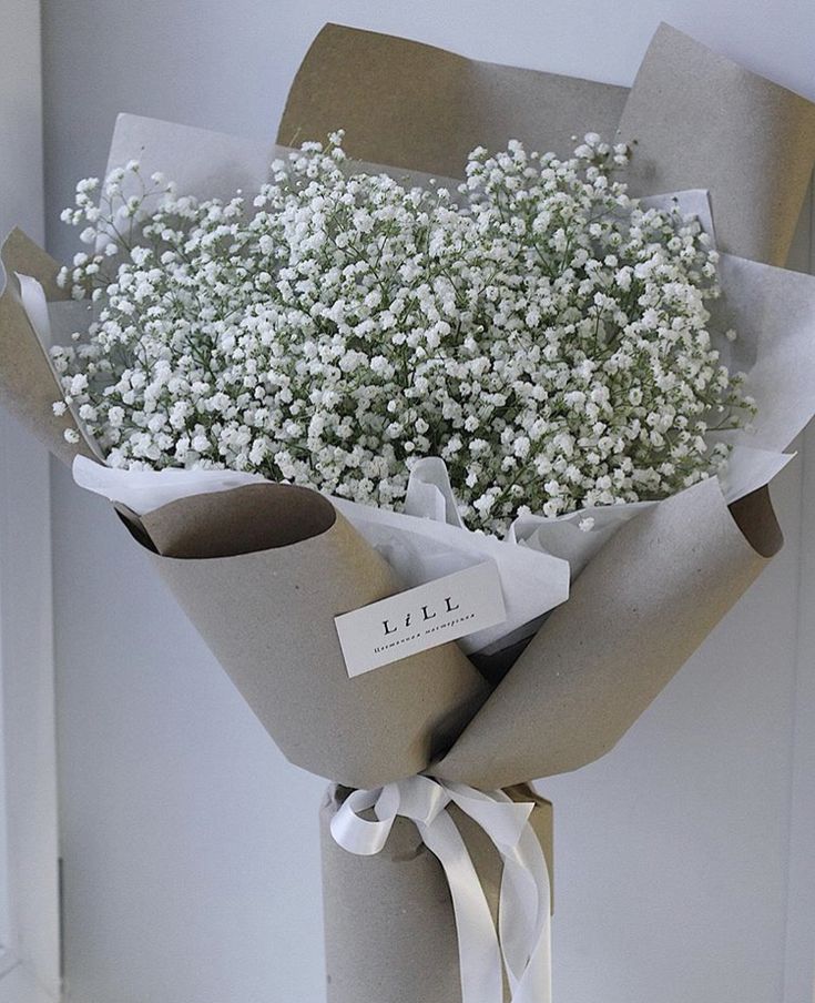 a bouquet of baby's breath wrapped in brown paper