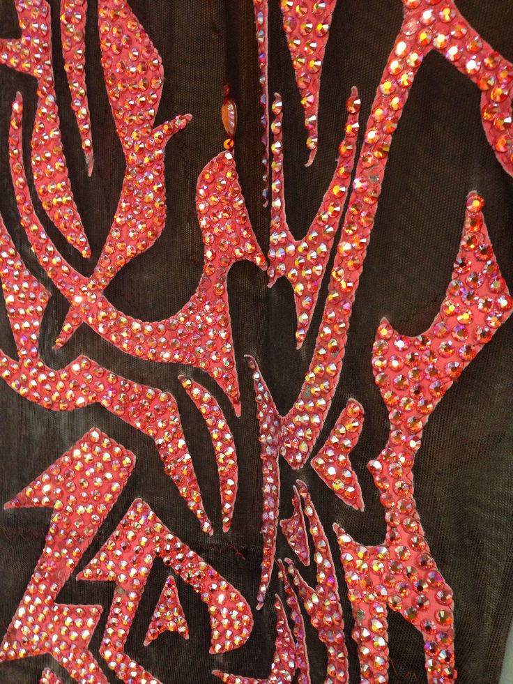 the back of a black shirt with red and pink sequins