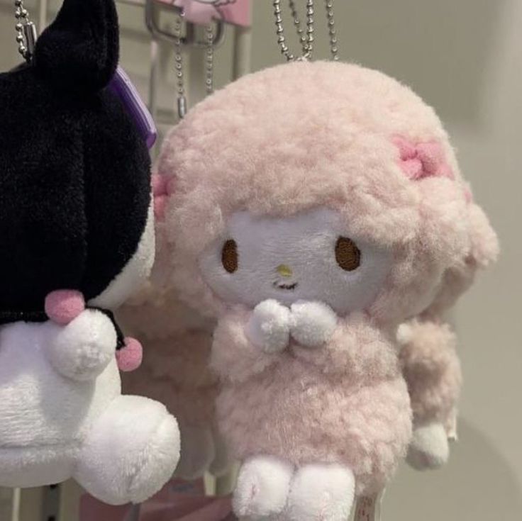 two stuffed animals hanging from hooks in a room