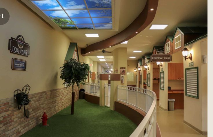 the inside of a building that has a green carpet and white railings on both sides