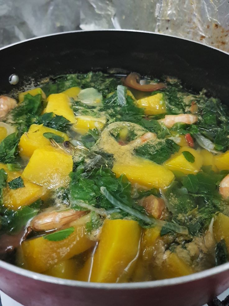 a pan filled with food sitting on top of a stove