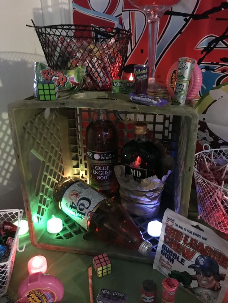 a table topped with lots of assorted items next to a wall covered in graffiti