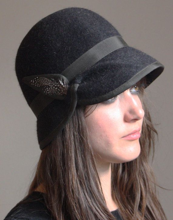 a woman wearing a black hat with a bow