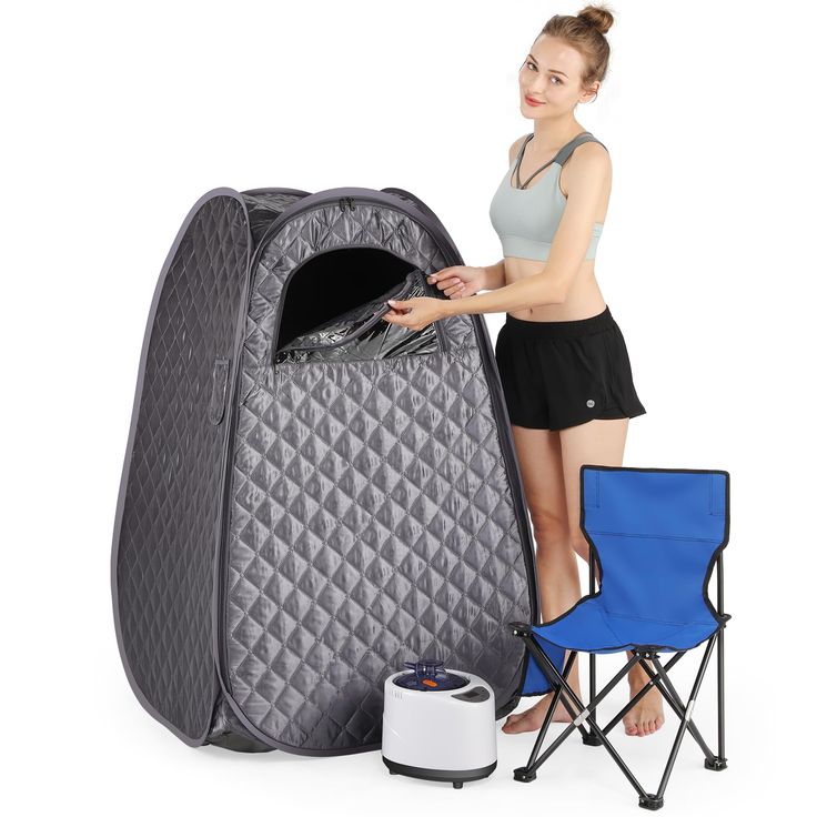 a woman standing next to an inflatable bed with a cooler on it's side