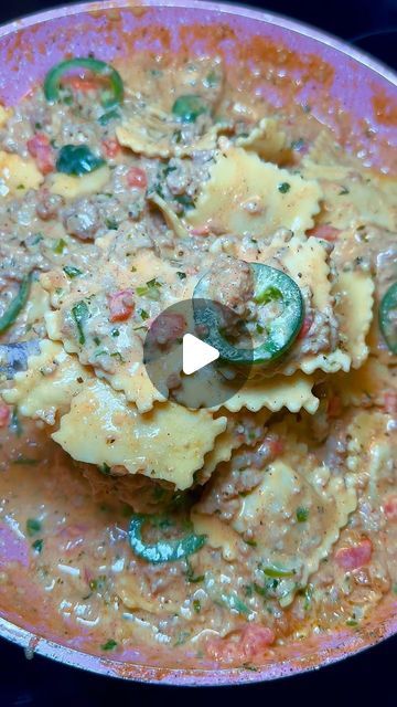 a bowl filled with pasta and meat covered in sauce