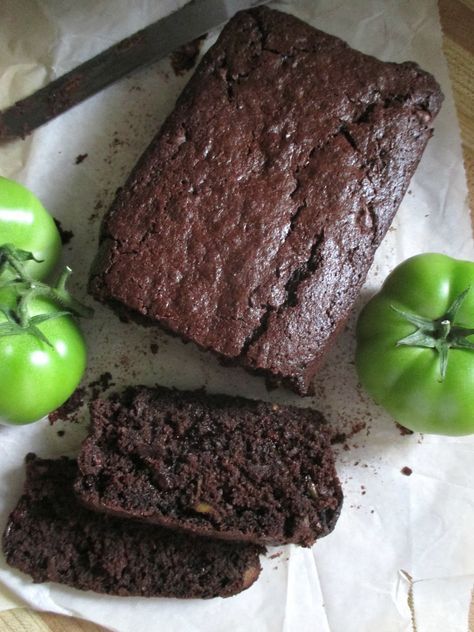 some brownies and green tomatoes on a piece of wax paper next to a knife