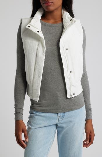 Add a light layer to your cool-weather look with a zip-up puffer vest that's subtly cropped for a contemporary silhouette. 20" length Front zip closure with snap storm placket Stand collar Front welt pockets Ribbed hem Lined, with synthetic fill 100% nylon Hand wash, dry flat Imported Sleeveless Nylon Puffer Jacket For Spring, Spring Nylon Puffer Vest, Sleeveless Puffer Jacket For Spring, Everyday Spring Nylon Outerwear, Sporty Spring Outerwear Vest, Trendy Nylon Spring Vest, Trendy Nylon Vest For Spring, Trendy Spring Nylon Vest, Fitted Sporty Puffer Jacket For Spring