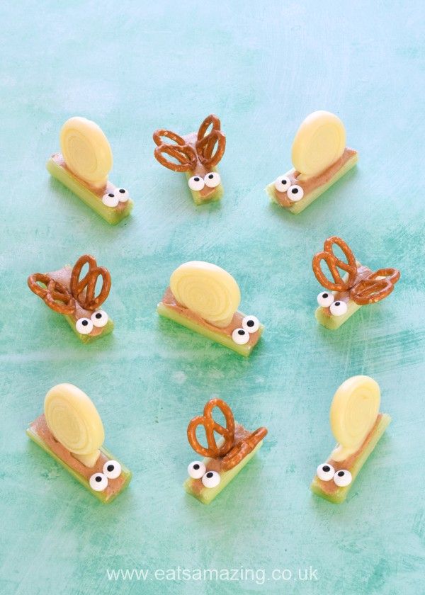 some pretzels with googly eyes are sitting on a blue surface and one has an eyeball in the middle