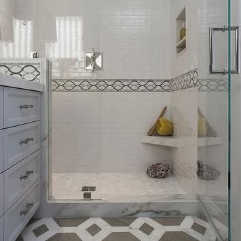 a walk in shower sitting next to a white cabinet