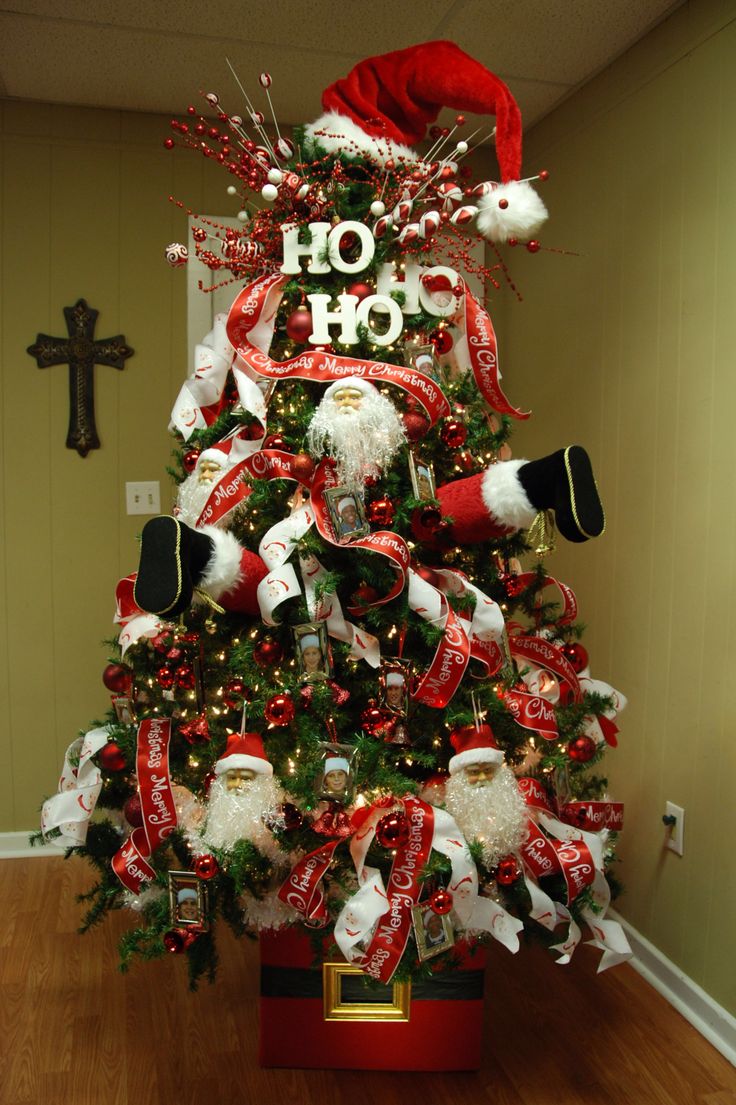 a christmas tree decorated with santa hats and stockings