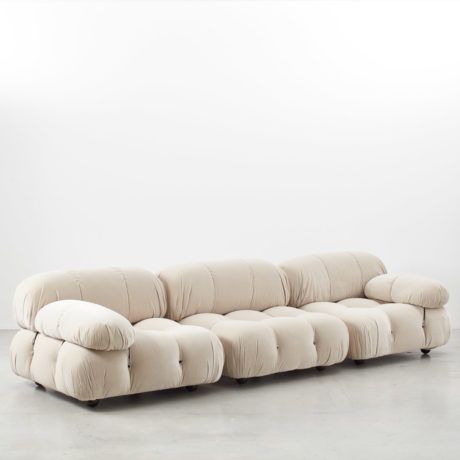 a white couch sitting on top of a cement floor