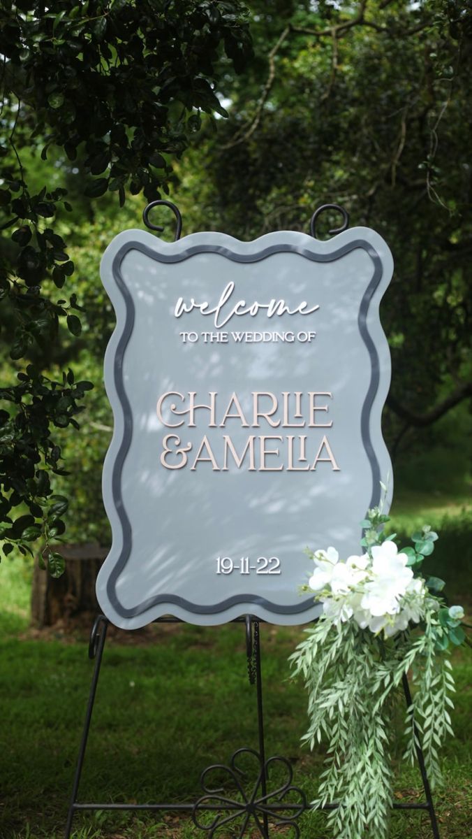 the welcome sign for charlotte and camelia is displayed in front of some trees with white flowers