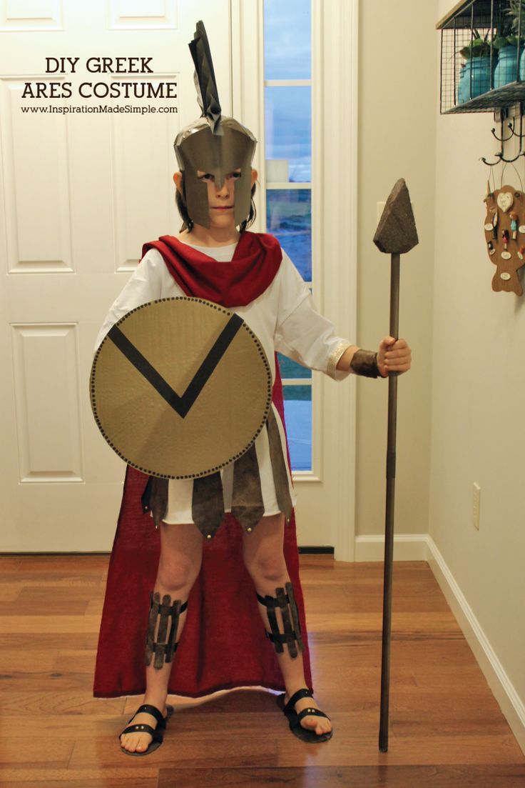 a man dressed as a roman soldier holding a spear and shield in his hand with the words diy greek ares costume on it