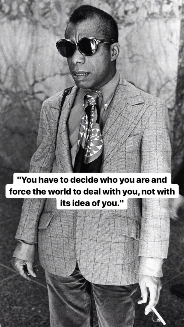 a man wearing sunglasses and a tie with a quote on it that says, baldwin is very difficult to talk about