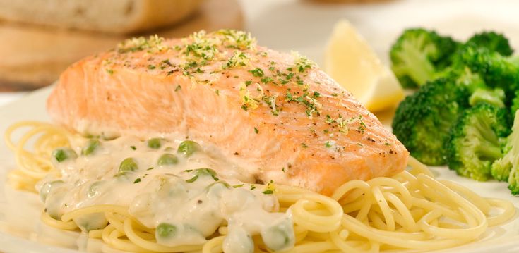 salmon and noodles on a plate with broccoli