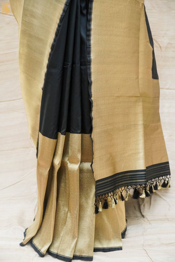 Category : Katan Silk Banarasi Saree Fabric - Pure Banarasi Katan Silk Weave – Kadhua weave Kadua is the traditional art of hand-stitched designs on pure silk yarn which is is a painstaking technique that requires skill and effort. Besides being labor-intensive the traditional kadua also requires skill and dexterity. Color – Black Blouse – Plain with border Length – Saree 5.5 meters and Blouse 1 meter Note- There may be slight color variations due to photographic reasons. This is a hand-woven pr Luxury Traditional Katan Silk Wear, Cheap Katan Silk Saree With Pallu Detail, Bollywood Style Ceremonial Traditional Slub Silk Wear, Unstitched Slub Silk Traditional Wear For Ceremonial Use, Ceremonial Slub Silk Dupatta With Zari Work, Black Tussar Silk Handloom Blouse Piece, Black Handloom Tussar Silk Blouse Piece, Black Raw Silk Traditional Wear With Patterns, Black Traditional Wear With Raw Silk And Traditional Patterns