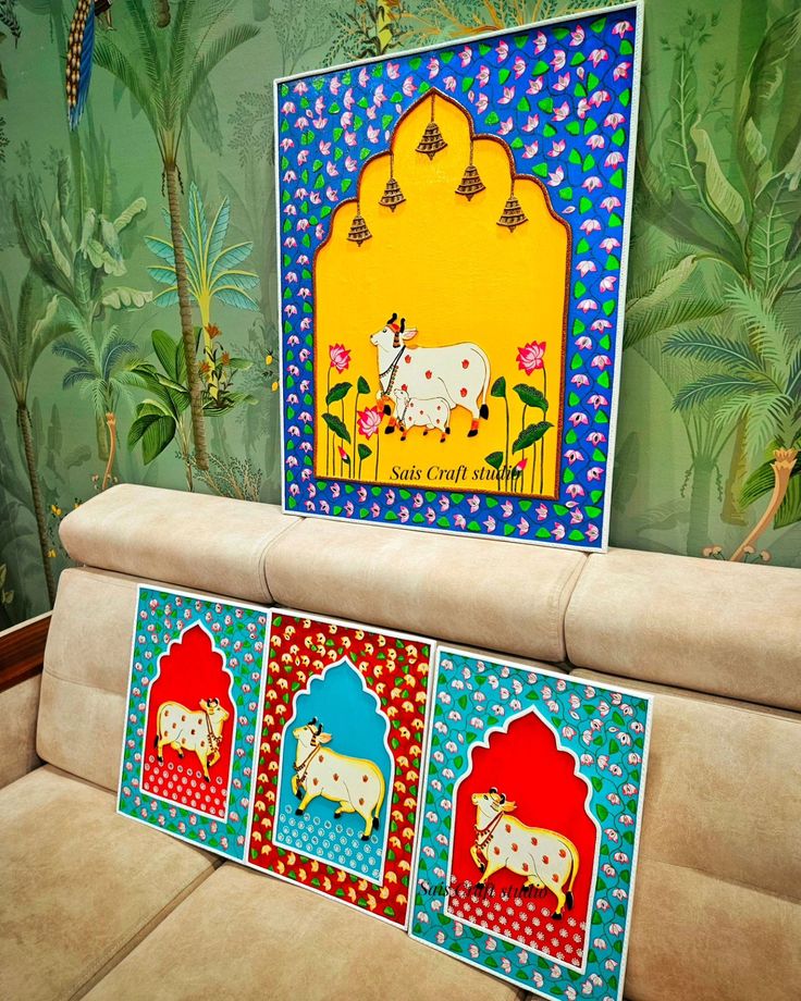 the couch is decorated with colorful paintings on it's back and side panels, along with decorative wall hangings