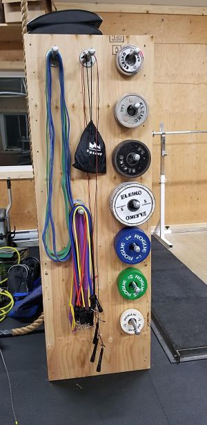 a wooden board with many different types of wires and buttons attached to the back of it