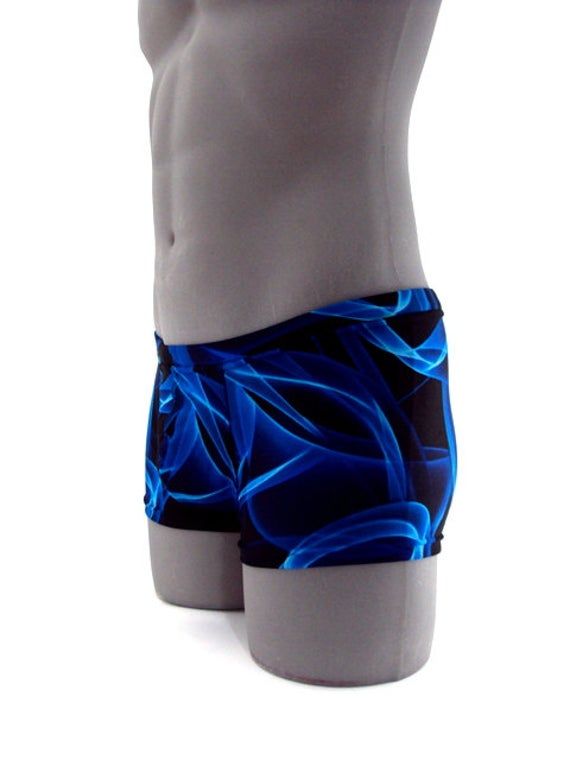 "Designed with a vibrant look sure to turn heads,this men's swimsuit lights up the beach or pool in refreshing style,this eye-catching stretch nylon square cut swimsuit for men stands out for all the right reasons. MADE IN USA PLEASE NOTE: All print fabric designs swimsuits varies, no two are alike. Drawcord waist 7\" Inch Side seams 3/4 inch waist elastic 3/8 inch leg elastic Center seam front pouch" Blue Swimwear With Built-in Shorts For Swimming, Blue Fitted Boxer Briefs For Summer, Fitted Blue Boxer Briefs For Summer, Summer Fitted Blue Boxer Briefs, Fitted Blue Boxer Briefs With Built-in Shorts, Fitted Boxer Briefs For Surfing And Beach Season, Blue Stretch Boxer Briefs For Beach Season, Blue Fitted Short Length Swim Trunks, Blue Stretch Swim Trunks