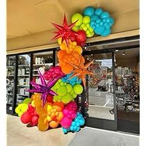 a bunch of balloons that are in the shape of a starfish on a pole