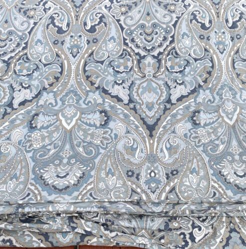 an image of a blue and white paisley print fabric on a wooden surface with wood flooring