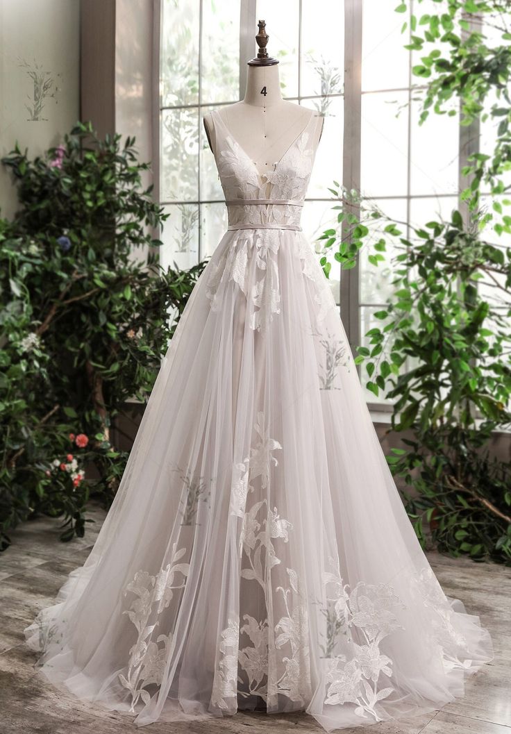 a wedding dress on display in front of a window