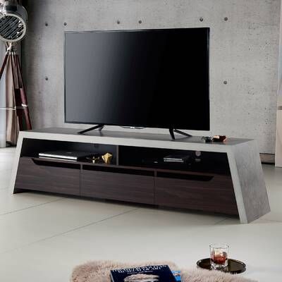 a large flat screen tv sitting on top of a wooden entertainment center in a living room