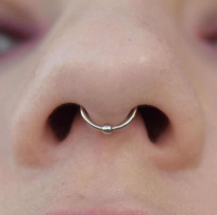 a woman with a nose ring on her nose