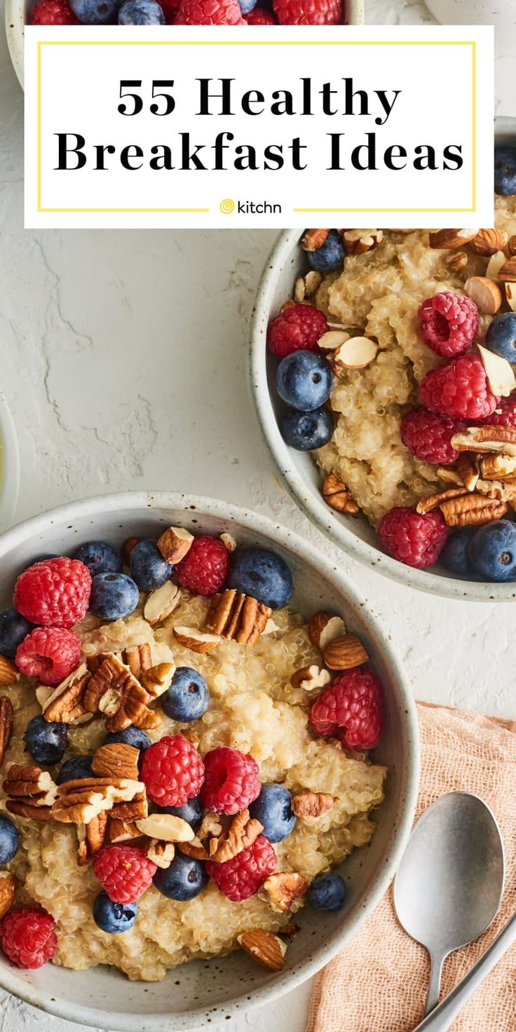 two bowls filled with oatmeal and berries on top of a white table