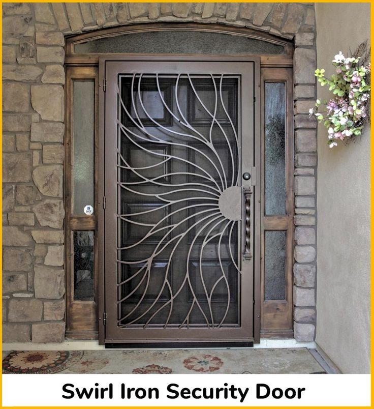 an iron door with decorative glass in front of a stone wall and rug on the floor