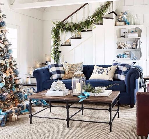 a living room filled with furniture and a christmas tree in the middle of the room