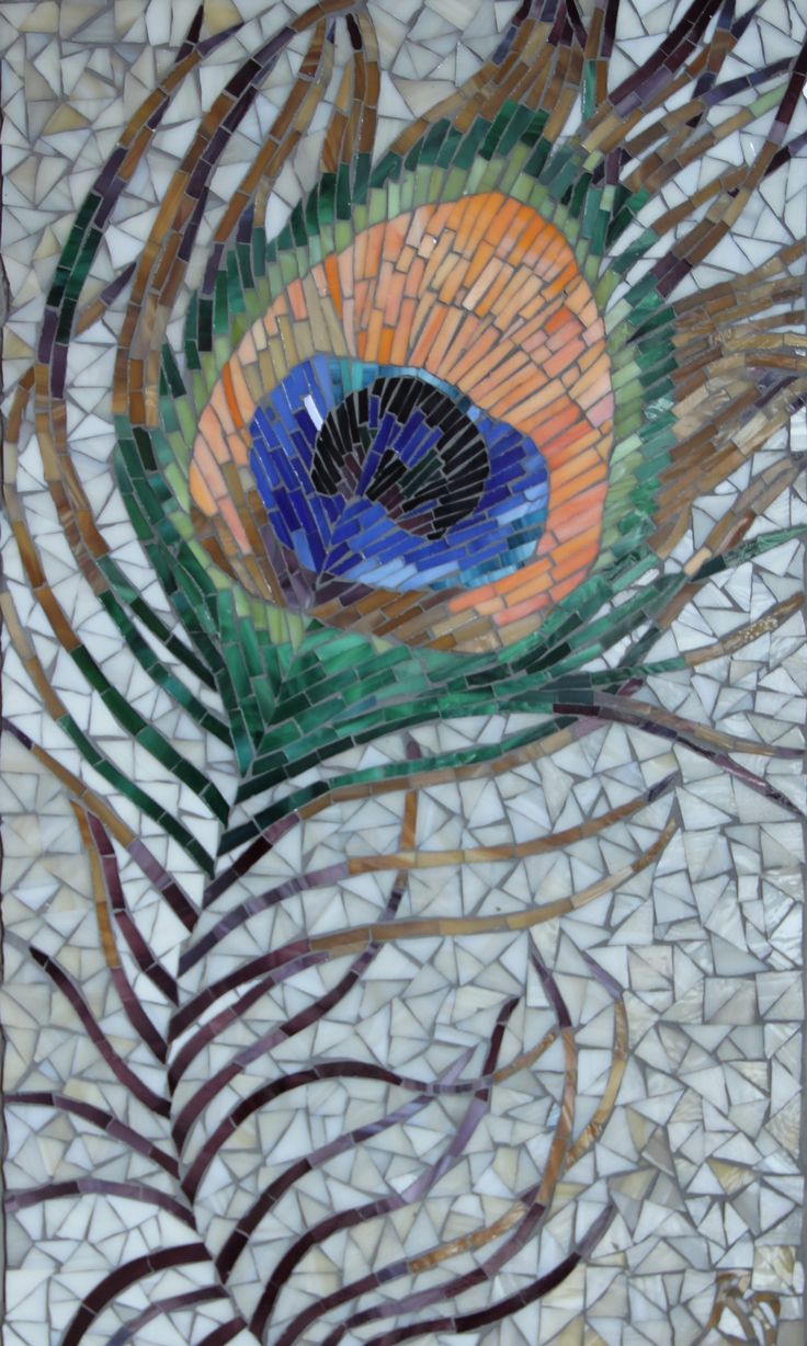 a peacock feather is shown on a mosaic tile wall