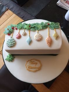 a cake decorated with christmas decorations on top of a table