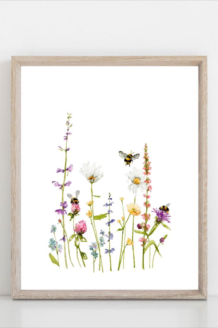 a white wall with some flowers and a butterfly on the top of it, next to a wooden frame