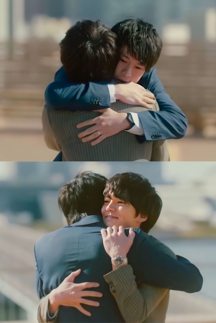 two people are hugging each other and one is wearing a suit