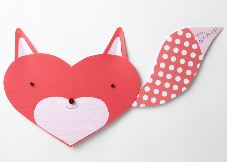 a paper heart shaped like a fox with polka dots on it and a piece of paper cut out to look like an animal