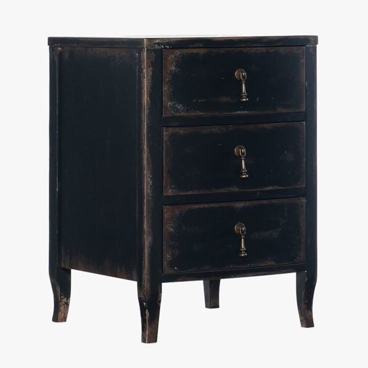 an old black wooden cabinet with three drawers