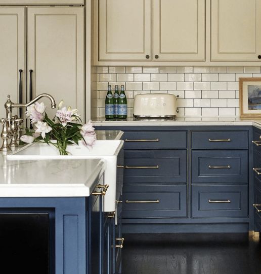 a kitchen with blue cabinets and white counter tops