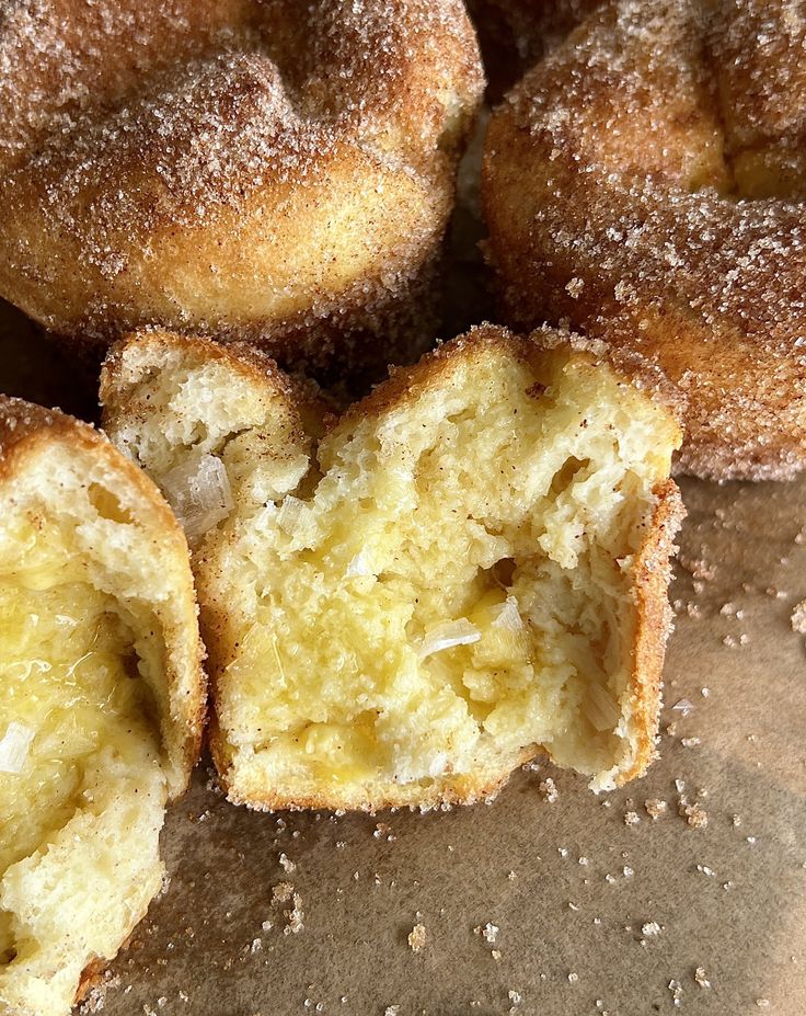 some sugared doughnuts sitting on top of a table