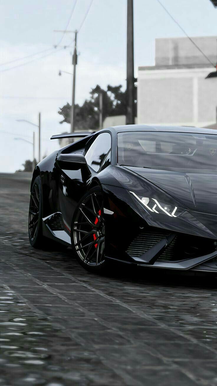 a black sports car driving down a street