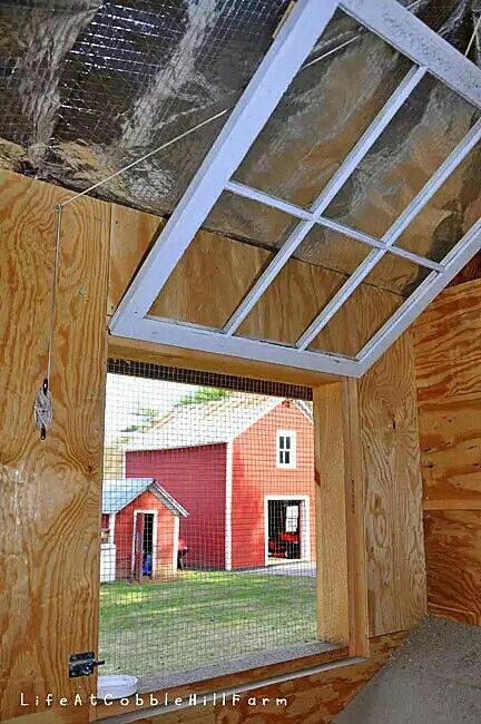 an instagramted photo of a red barn with the window open to let in light