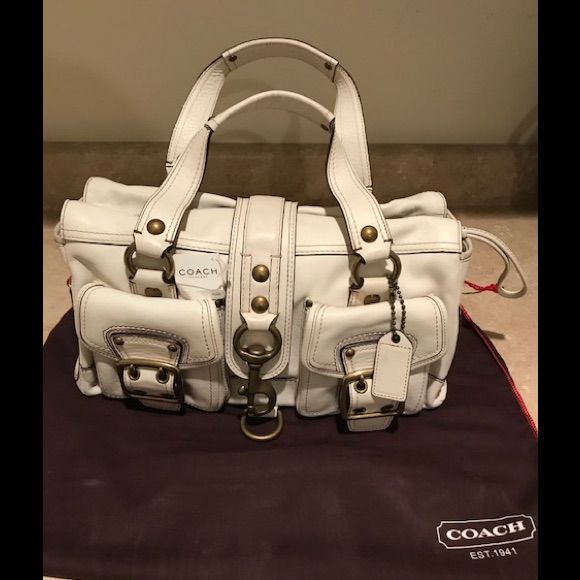 Coach Handbag With Beautiful Interior Lining And Brass Detailing On Exterior. Brand New, But Unfortunately There Are Some Small Discoloration From The Brass Detailing As Seen In Photos. Originally Paid $629 But Reduced Price Listed Due To Disclosed Markings. White Designer Bag With Top Carry Handle, White Designer Bags With Top Carry Handle, Designer Satchel With Branded Hardware, Designer White Satchel With Top Carry Handle, Designer White Satchel For Travel, Travel Tote Bag With Branded Hardware, White Rectangular Shoulder Bag With Branded Hardware, Designer White Office Bag, Designer White Satchel Shoulder Bag