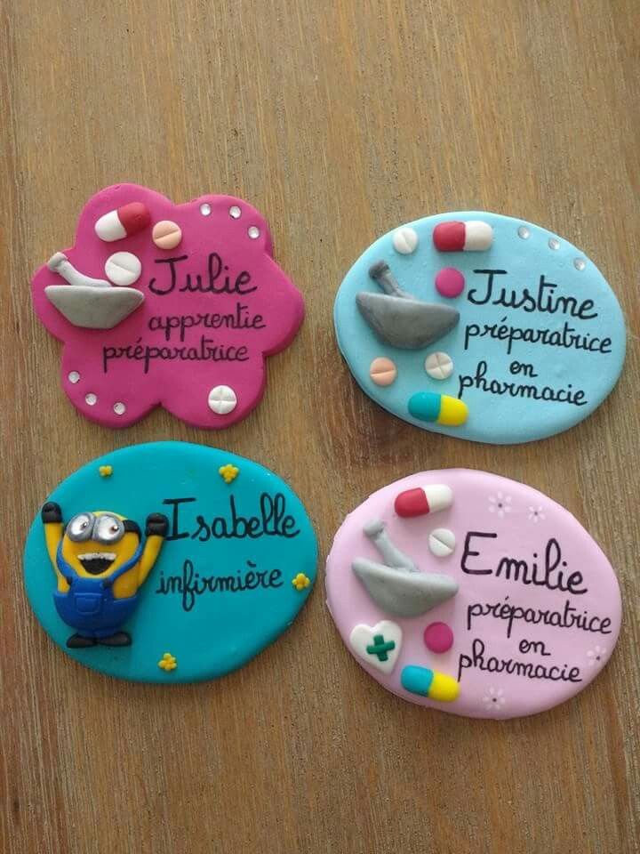 three decorated cookies sitting on top of a wooden table with words written in different languages