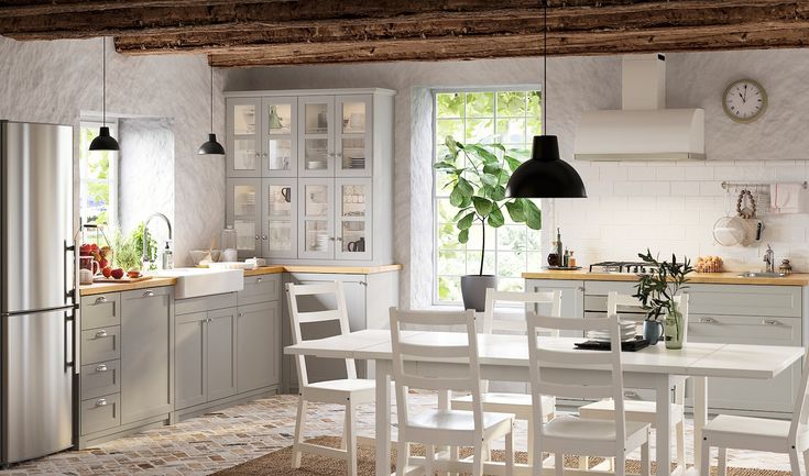 the kitchen is clean and ready to be used for dinner or lunchtime, with all white furniture