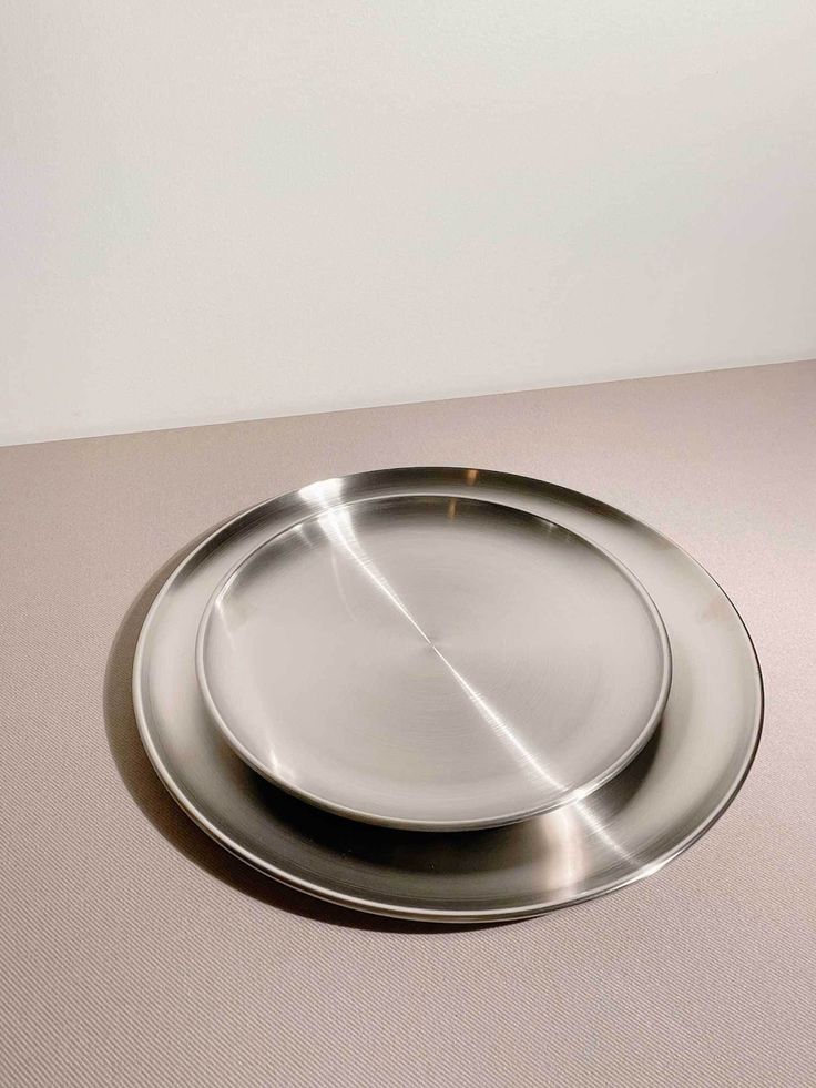 a silver plate sitting on top of a table