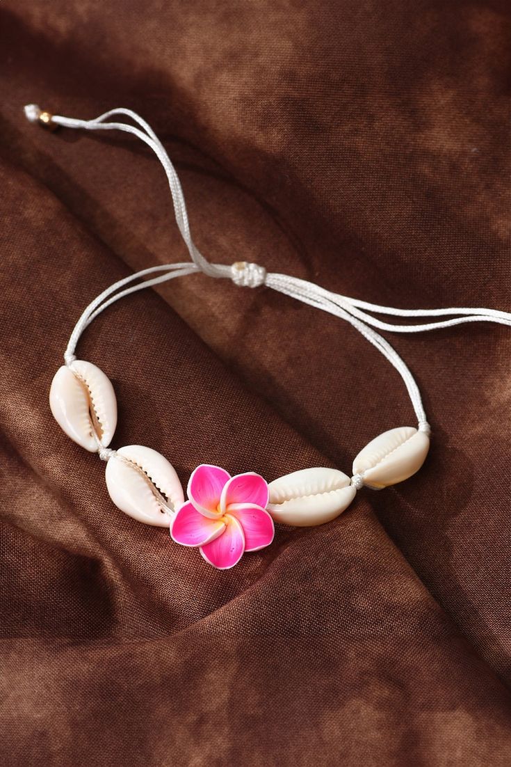 Experience the beauty of the ocean with our White Flower Seashell Adjustable Bracelet. Handcrafted with delicate white seashells, this bracelet adds a touch of elegance to any outfit. The adjustable design ensures a perfect fit for all. Bring a piece of the sea wherever you go. Flowers And Seashells, White Seashells, Polymer Clay Bracelet, Formal Wear Dresses, Clay Bracelet, Silk Pajama Set, Delicate Flowers, Beach Vibes, Delicate Flower