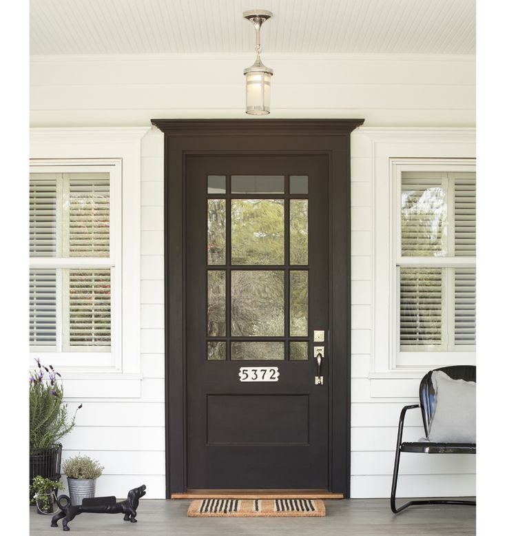 a black front door on a white house