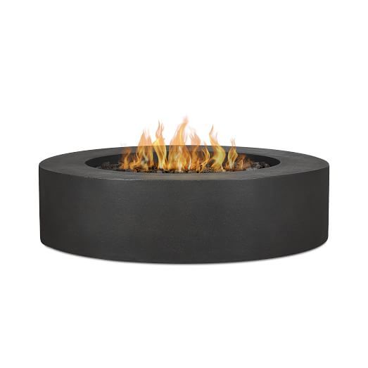 the outdoor great outdoors fire pit is shown in black with flames coming out of it