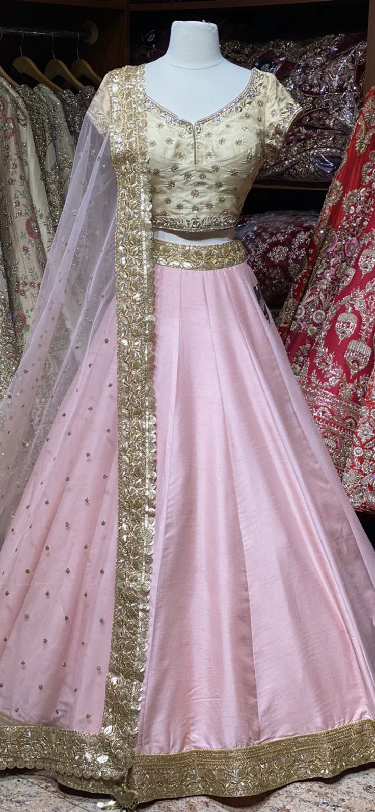 Ballerina pink skirt with gold sequins lace border teamed with contrasting gold floral zardozi, cut dana and stone work blouse and net dupatta. Fabric: Raw Silk This outfit can be customized in multiple colors and specific to client measurements. 90 days of production time is required and are for bulk orders only! Orders are processed in store only! Final fittings/alterations not included. Minimum Order Quantity- 4 pieces Embellished Tissue Silk Lehenga For Festivals, Bollywood Style Embellished Tissue Silk Lehenga, Raw Silk Wedding Dress With Gota Work, Wedding Dresses In Raw Silk With Gota Work, Raw Silk Dress With Gota Work For Wedding, Pink Semi-stitched Raw Silk Choli, Gold Embellished Dress For Navratri, Embellished Gold Dress For Navratri, Pink Raw Silk Set With Zari Work